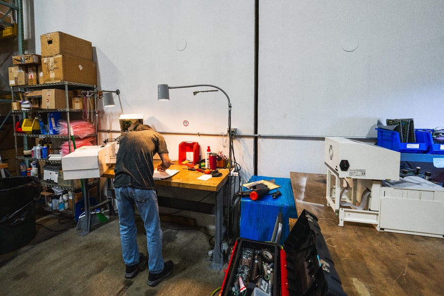 Technician servicing a machine at the Louisville repair station