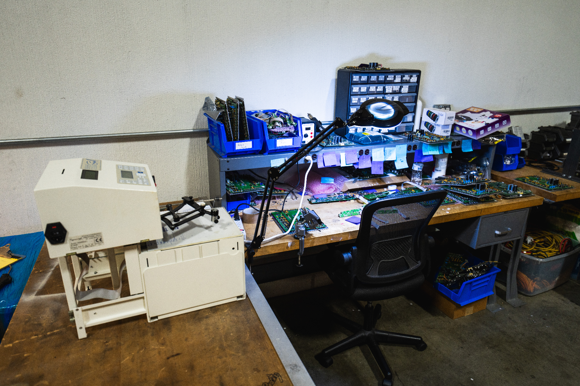 UniProd support and repair bench with circuit boards and diagnostic tools