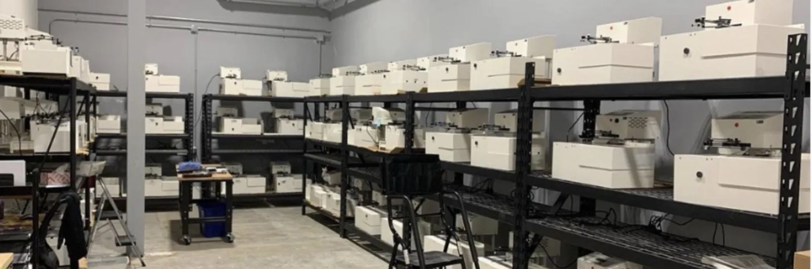 UniProd machines staged on warehouse shelving, ready to ship
