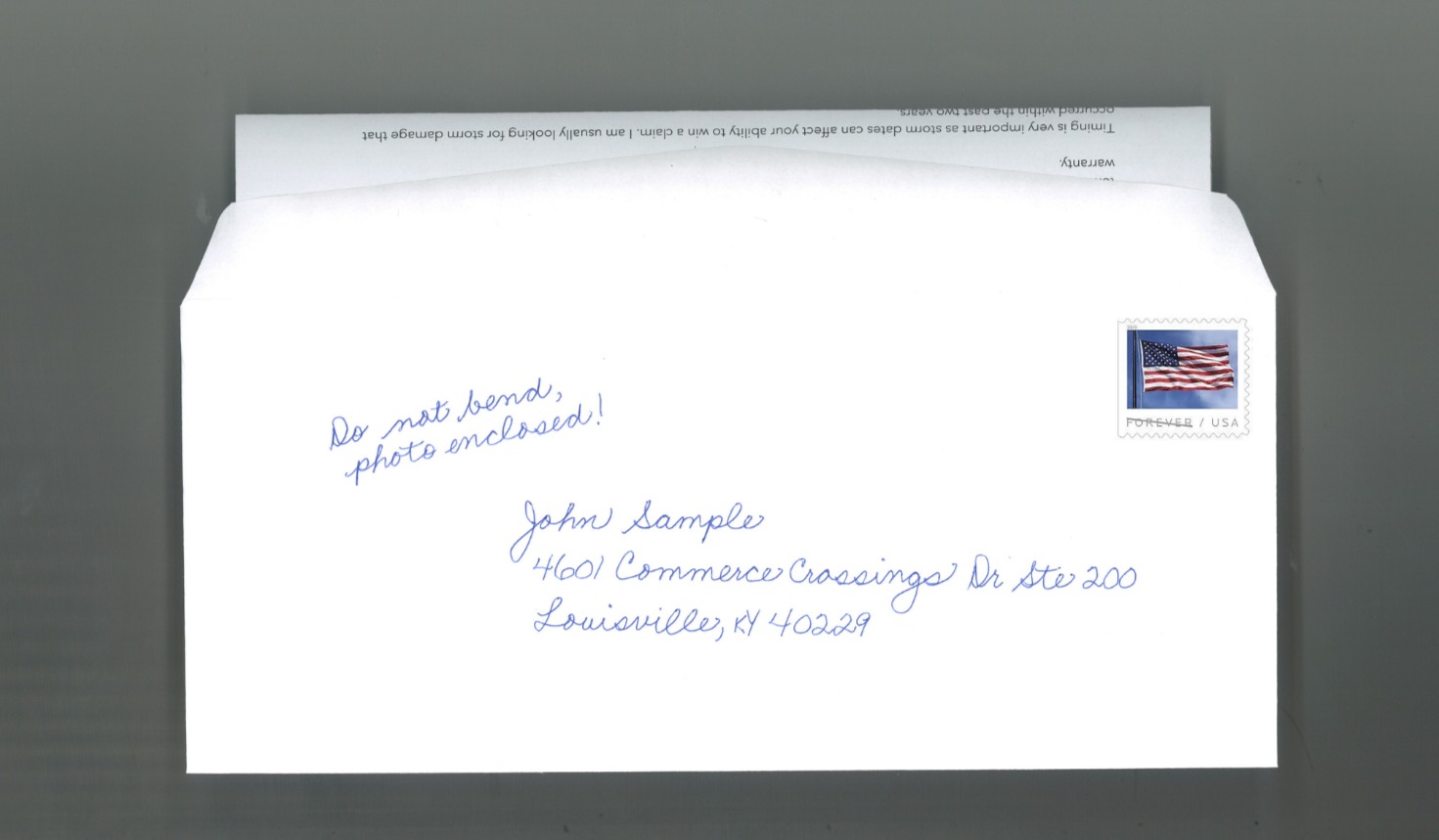 Handwritten envelope with small note on the front