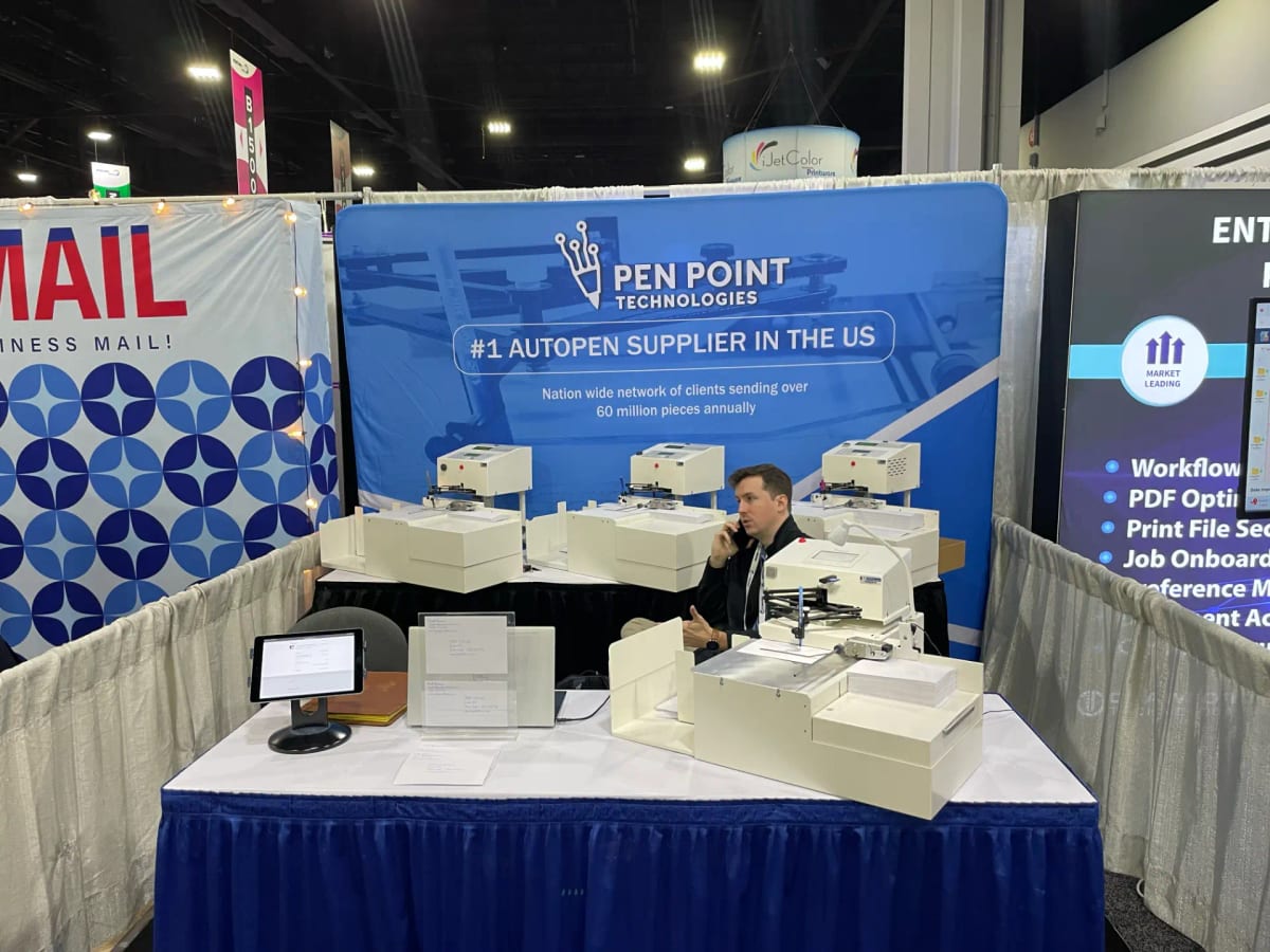 The Pen Point Technologies trade-show booth with UniProd handwriting machines on the table